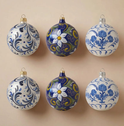 Set of 6 blue maiolica Christmas ornaments: two with blue scrolls, two with a white flower on blue, two with blue roses