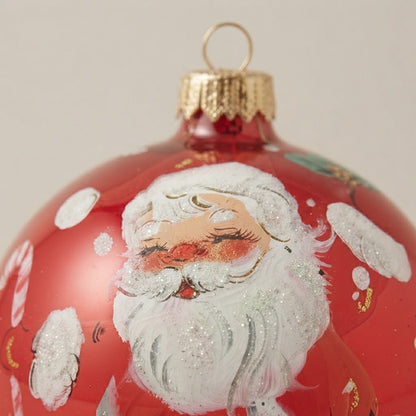 Brush-painted decoration detail: Santa Claus in the snow on red