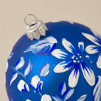 Brush-painted decoration detail: white flowers on blue