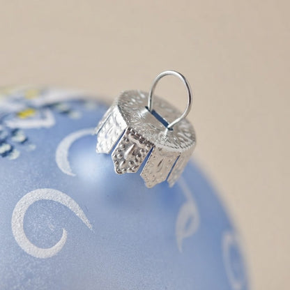 Back of the light blue blown glass Christmas teardrop ornament