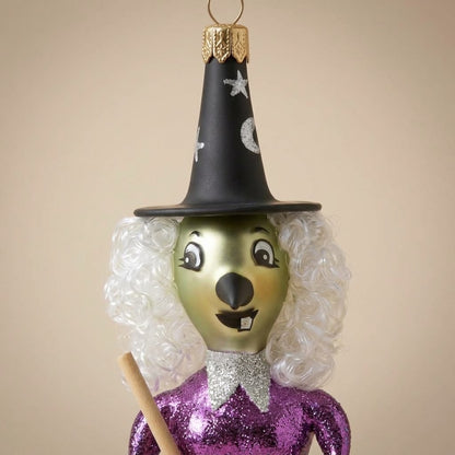 Green face and hat with stars and moon of the purple witch